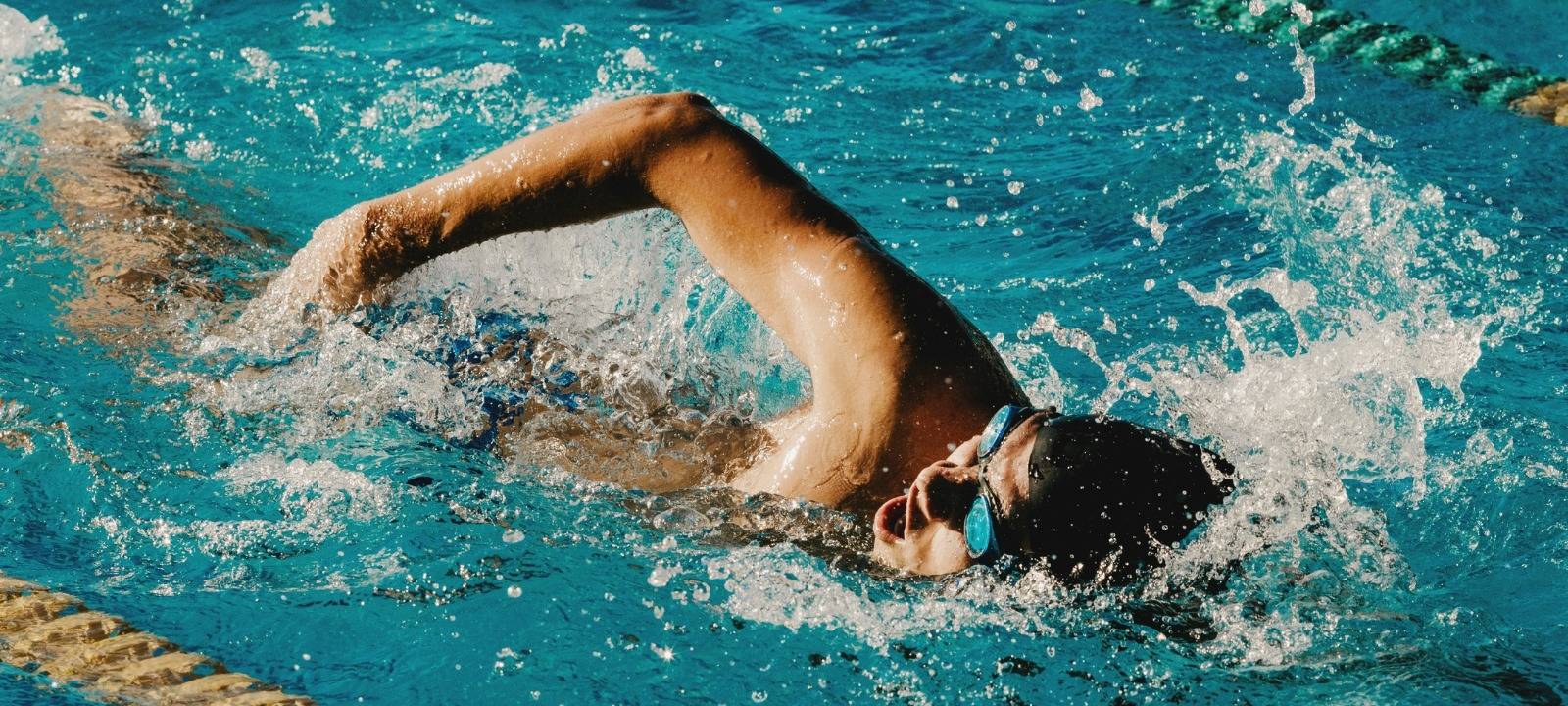 Ein Mann schwimmt durch ein Becken in einem Schwimmbad.